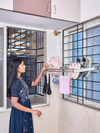 Wall-mounted smart drying rack next to a shoe organizer